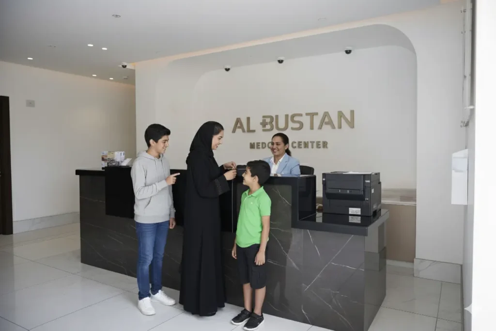 Al Bustan Plus Medical Center, Reception Area with Happy Family